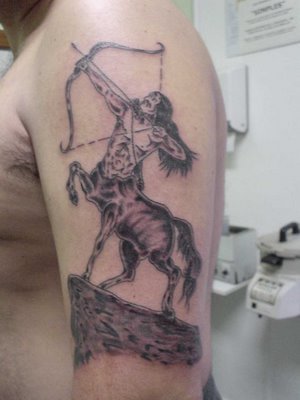 A man showing an angel warrior tattoo carved on his bicep warrior tattoo 19